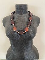 Full view of necklace on bust showing square beads and spacing