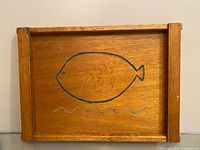 Front view of entire wooden tray showing fish painting