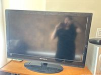 Front view of 32" Dynex TV on stand