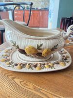 gravy boat on underplate profile view showing fruit relief