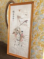 Full framed embroidered panel on tabletop