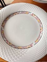 Front view of plate showing textured rim and floral border
