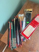 All chopsticks laid out on table including sealed packs and loose pairs