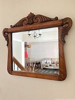 front view of carved wood wall mirror showing frame details and size
