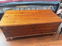 Top view of closed wooden chest showing finish, hardware, and size