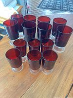 All 14 red glass goblets grouped on table