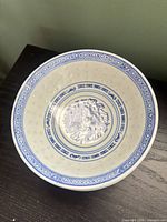 Single bowl showing interior dragon motif and decorative borders