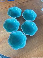 All five turquoise scalloped bowls on table