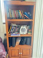 Full view of bookcase loaded with books and items