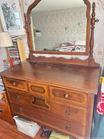 Full view of dresser with attached mirror, drawers and hardware visible
