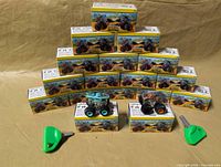 Stack of 15 sealed boxes plus 2 unboxed trucks and keys