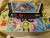 Overall view of open plastic case, rolled mat, miniatures and standees arranged