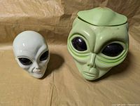 Front view of both alien head items