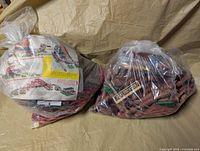 Both sealed bags side by side showing quantity of toy parts