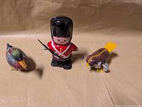 Group shot of tin duck, soldier and bird toys