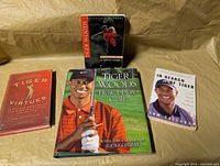 All four Tiger Woods books laid out front covers visible