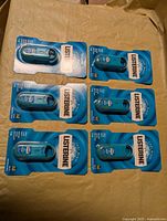 Six sealed Listerine Pocketmist sprays laid out