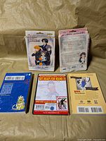 Front of Fruits Basket TCG box, back of second box; spines and back covers of three books/DVD