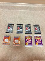 Overview of all eight sealed packs arranged in two rows