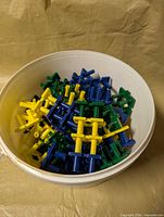 Top view of pail filled with plastic building pieces in multiple colours