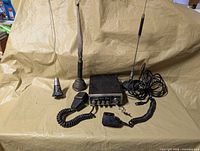 Front view of CB radio, microphone, three antennas laid out