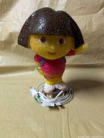 Front view of Dora the Explorer lamp with coiled power cord