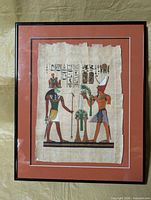Front view of framed papyrus artwork showing figures and hieroglyphics