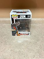 Front view of boxed Cyberdemon Pop! showing figure and Doom #91 labeling