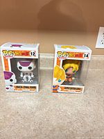 Front view of both Funko Pop boxed figures showing characters and numbering