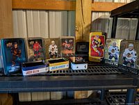 Full lot view showing all nine empty trading card tins on shelving