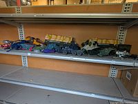 Full shelf view showing assorted GI Joe vehicle bodies and parts