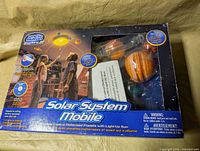 Front of box showing product name and window revealing planets