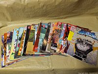 Full stack of 30 comic books fanned out on table