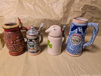 Four steins lined up showing overall lot