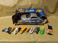 Lot overview showing boxed Audi TT and ten smaller vehicles