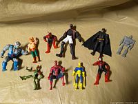 Group shot of all ten action figures on fabric backdrop