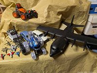 Group shot showing all vehicles including large airplane, RC cars, toy cars, helicopter, jets