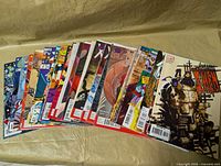 Entire lot of 30 comic books fanned out, showing covers