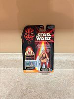 Front view of sealed Ric Olié action figure on card