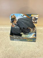 Factory-sealed package front showing Toothless dragon figure wings spread