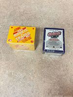 Both sealed card set boxes side by side