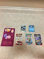 Entire lot: three sealed packs, two sealed promo cards, one sticker sheet