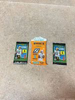 Front view of three sealed Panini NFL card packs