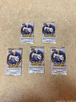 Front view of five sealed Upper Deck 2025-26 Series One hockey card packs