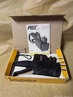 Pricing gun in box with manual visible