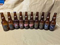 Front view of 11 Labatt Blue Original Six commemorative bottles lined up