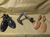 Overview of both shoe stretcher pairs and cobbler anvil