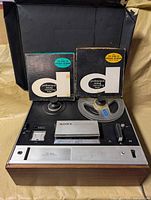 Front overview showing Sony TC-255 recorder with clear reel mounted and two boxed tapes