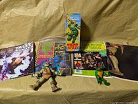 Overview of comics, magazine, boxed item, two figures and poster