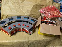 Overall lot showing roundhouse, box of track, trains, bridge panels